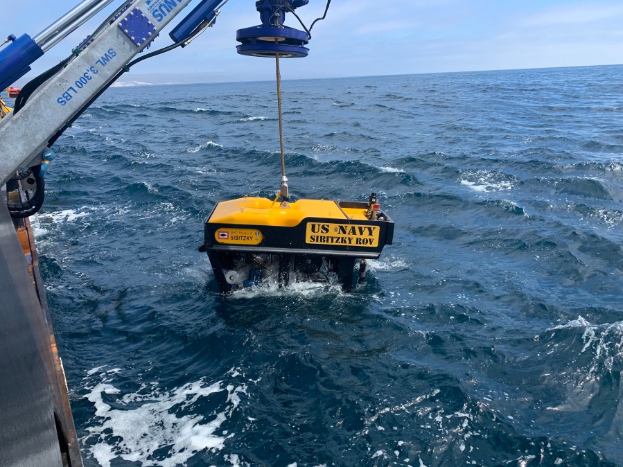 Crews deploy a remotely operated vehicle from the deck of a ship on Aug. 3, 2020, in the recovery of the seven Marines and one sailor missing off the coast San Clemente Island. (U.S. Navy / Lt. Curtis Khol)