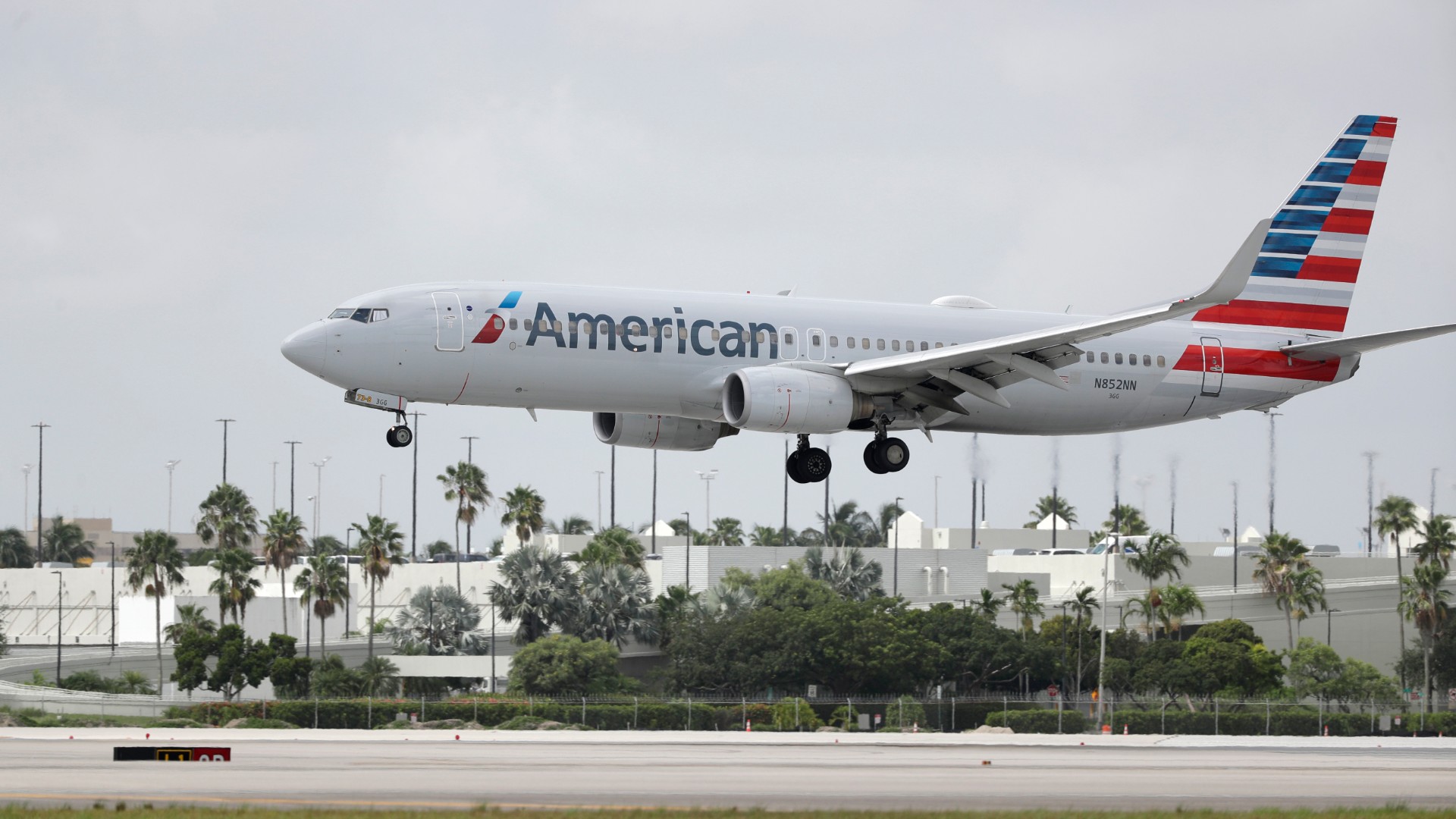 An American Airlines Boeing 737-823 lands at Miami International Airport, Monday, July 27, 2020, in Miami.American Airlines said Tuesday, Aug. 25 that it will furlough or lay off 19,000 employees in October as it struggles with a sharp downturn in travel because of the pandemic. Flight attendants will bear the heaviest cuts, with 8,100 losing their jobs. (AP Photo/Wilfredo Lee, File)