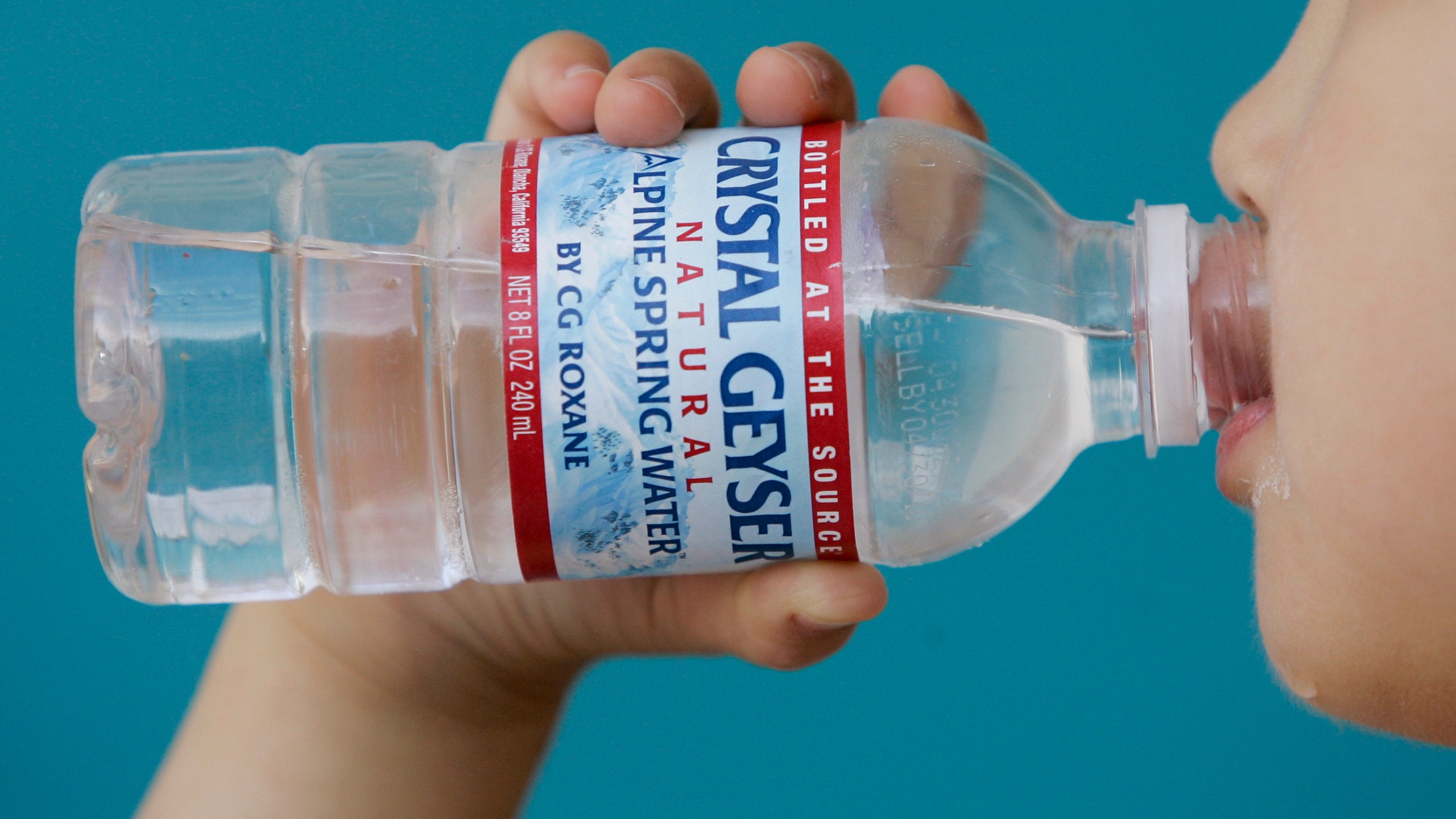 A child in Palo Alto drinks from a Crystal Geyser water in this May 3, 2008, file photo. (Paul Sakuma / Associated Press)