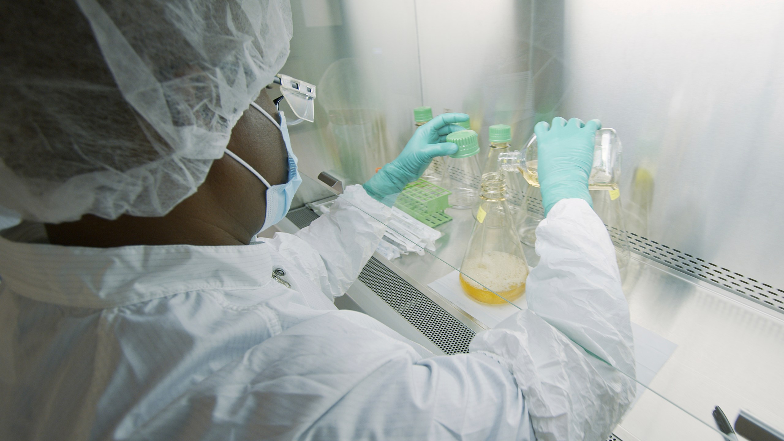 In this May 2020 photo provided by Eli Lilly, a researcher tests possible COVID-19 antibodies in a laboratory in Indianapolis. Antibodies are proteins the body makes when an infection occurs; they attach to a virus and help it be eliminated. (David Morrison/Eli Lilly via AP)