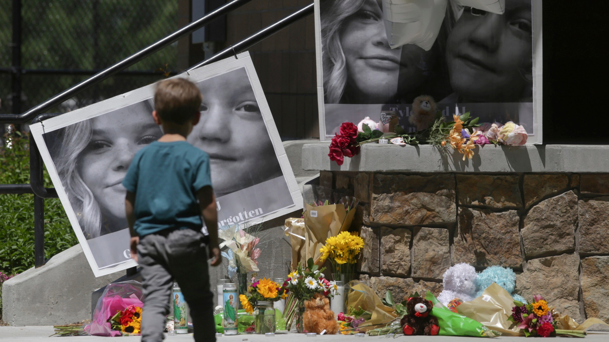 In this June 11, 2020, file photo, a boy looks at a memorial for Tylee Ryan, 17, and Joshua "JJ" Vallow, 7, at Porter Park in Rexburg, Idaho.