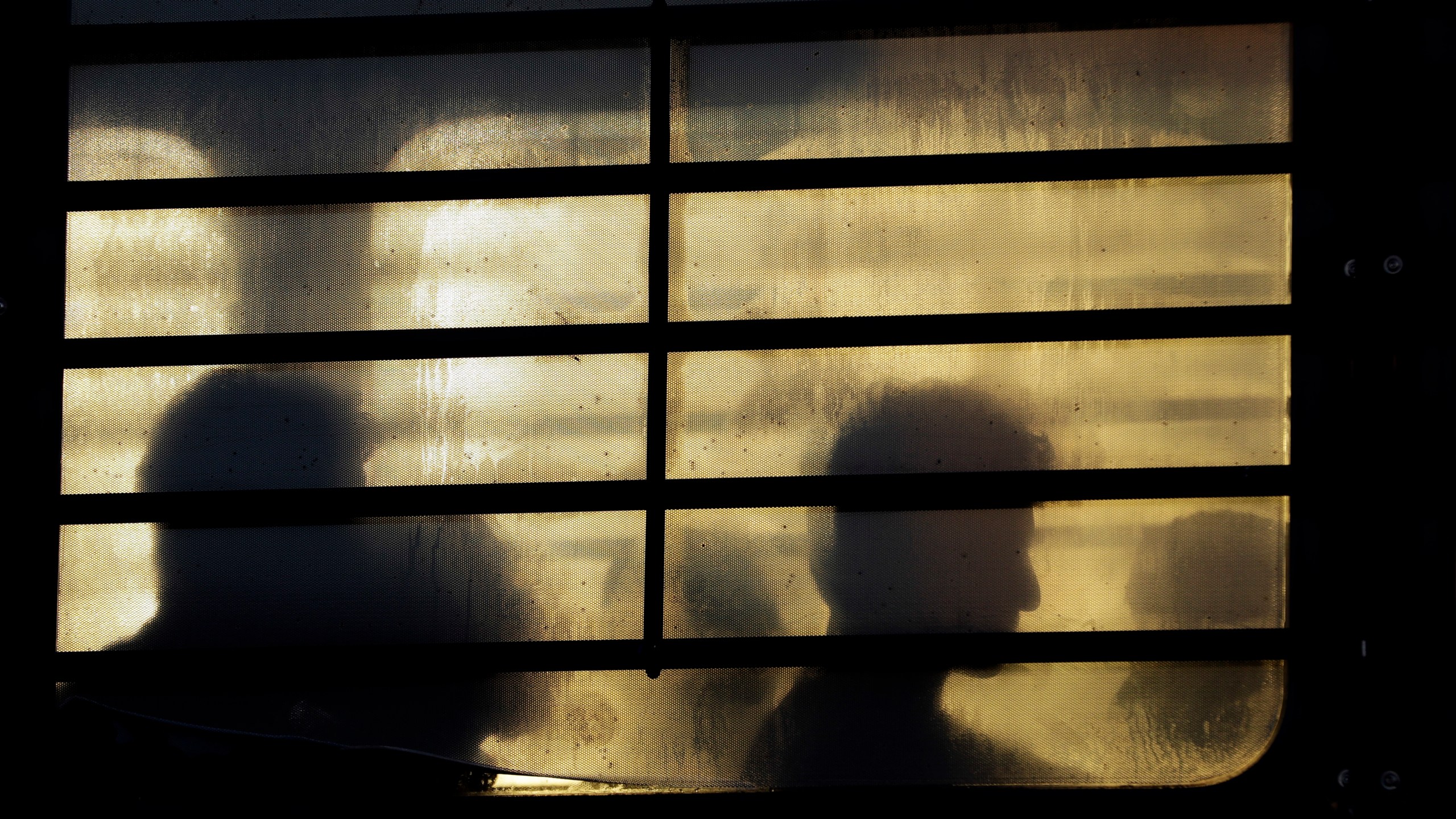 Immigrants who entered the United States illegally wait to board a plane for a deportation flight on Nov. 16, 2018. (David J. Phillip/Associated Press)