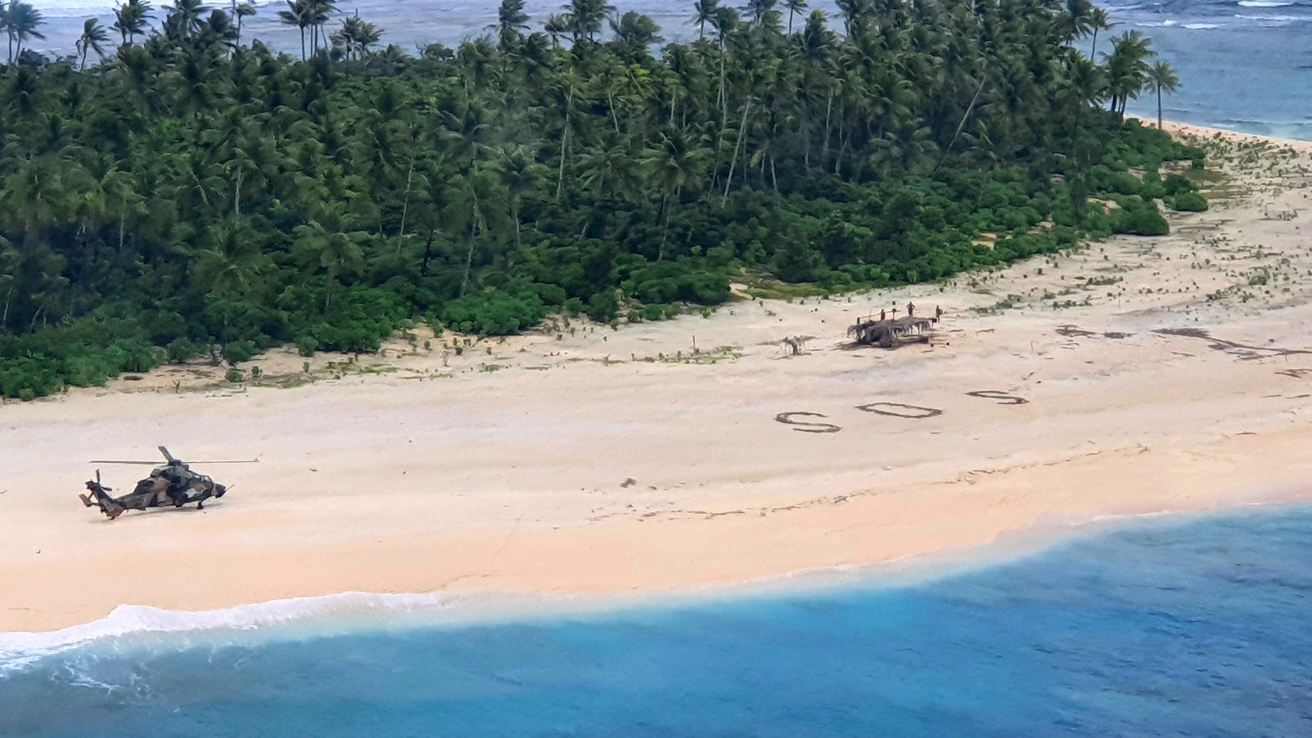 In this photo provided by the Australian Defence Force, an Australian Army helicopter lands on Pikelot Island in the Federated States of Micronesia, where three men were found, Sunday, Aug. 2, 2020, safe and healthy after missing for three days. (Australian Defence Force via AP)