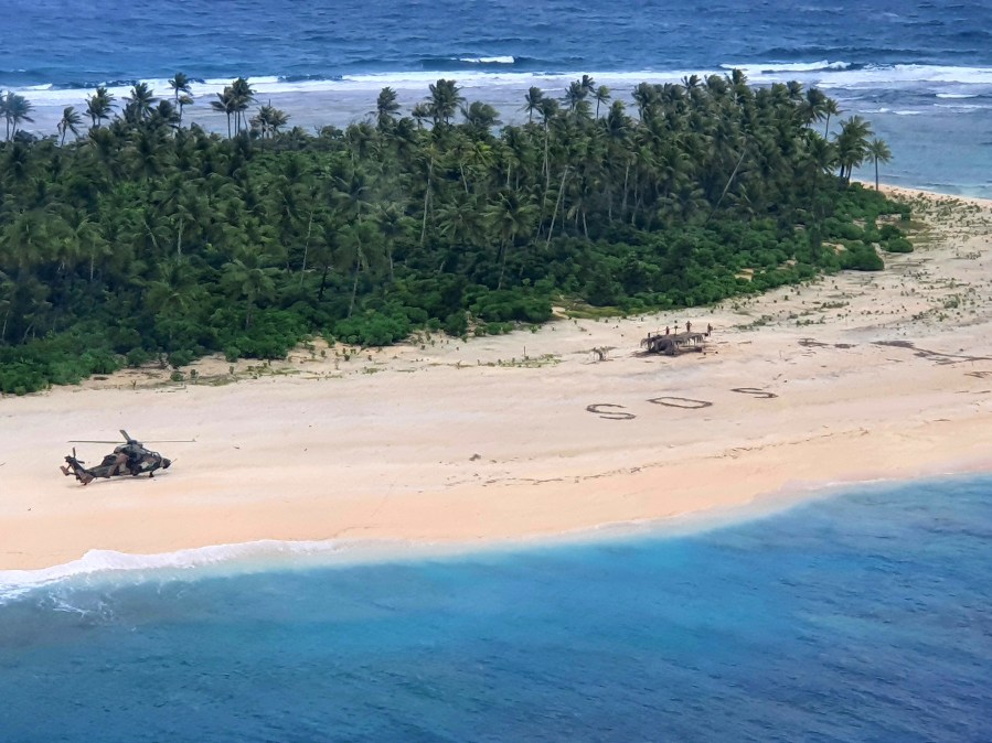 In this photo provided by the Australian Defence Force, an Australian Army helicopter lands on Pikelot Island in the Federated States of Micronesia, where three men were found, Sunday, Aug. 2, 2020, safe and healthy after missing for three days. (Australian Defence Force via AP)