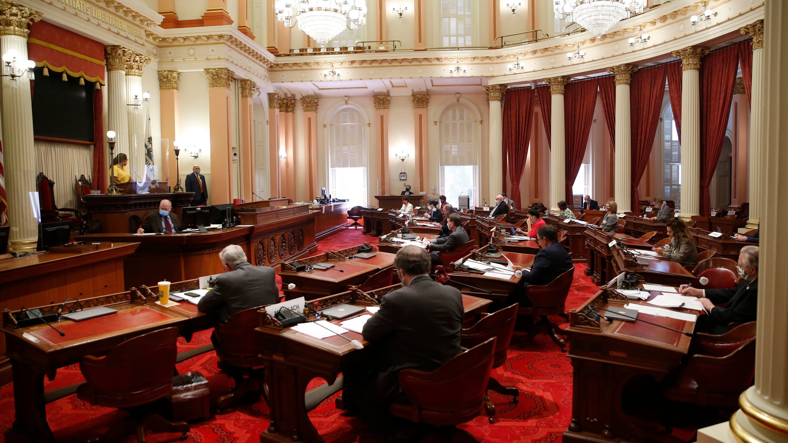 In this May 28, 2020, file photo, lawmakers wear face masks during a budget committee hearing in the Senate in Sacramento. (AP Photo/Rich Pedroncelli, File)