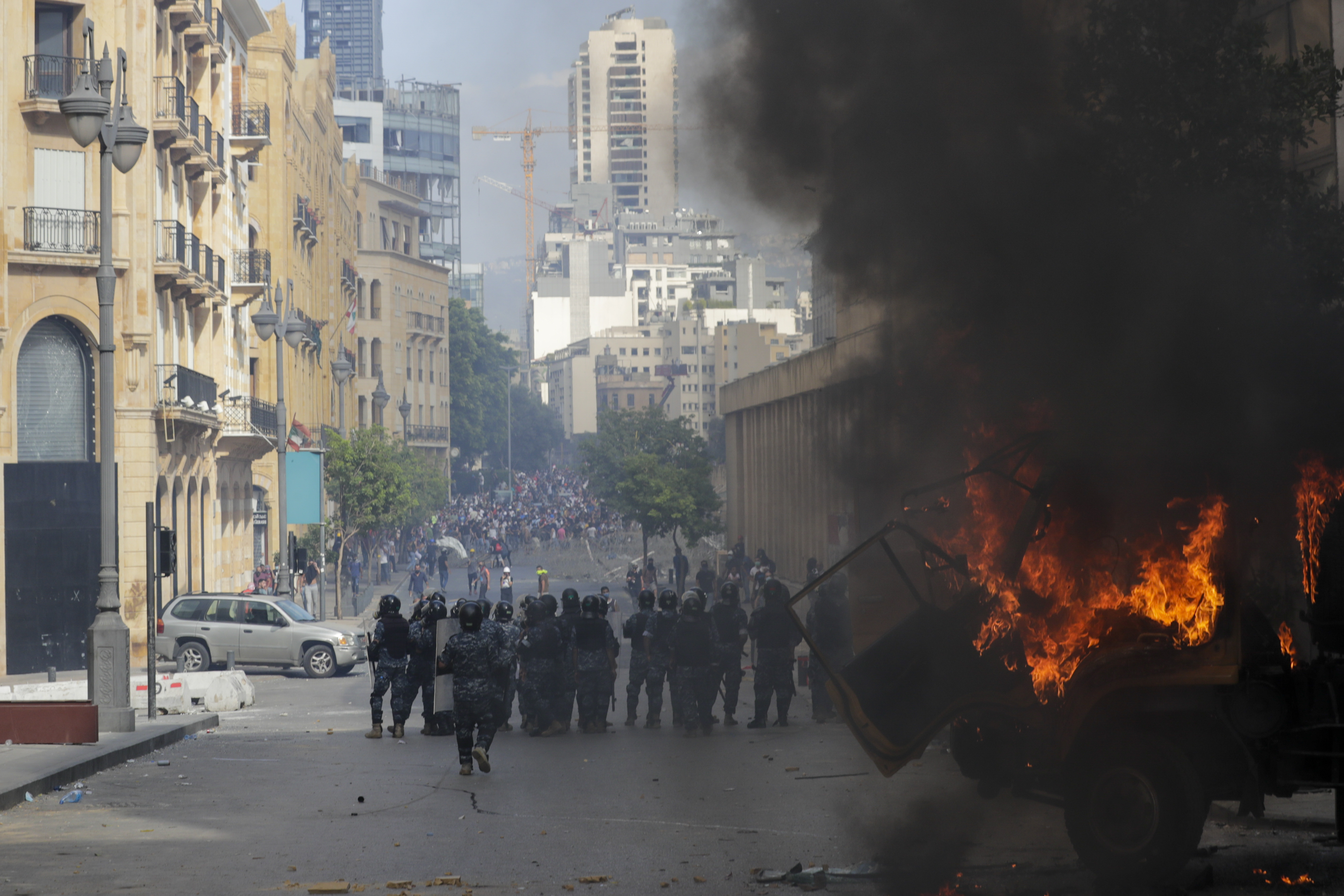 People clash with police during a protest against the government after the deadly explosion at Beirut port which devastated large parts of the capital and killed more than 150 people, in Beirut, Lebanon on Aug. 8, 2020. (AP Photo/Hassan Ammar)