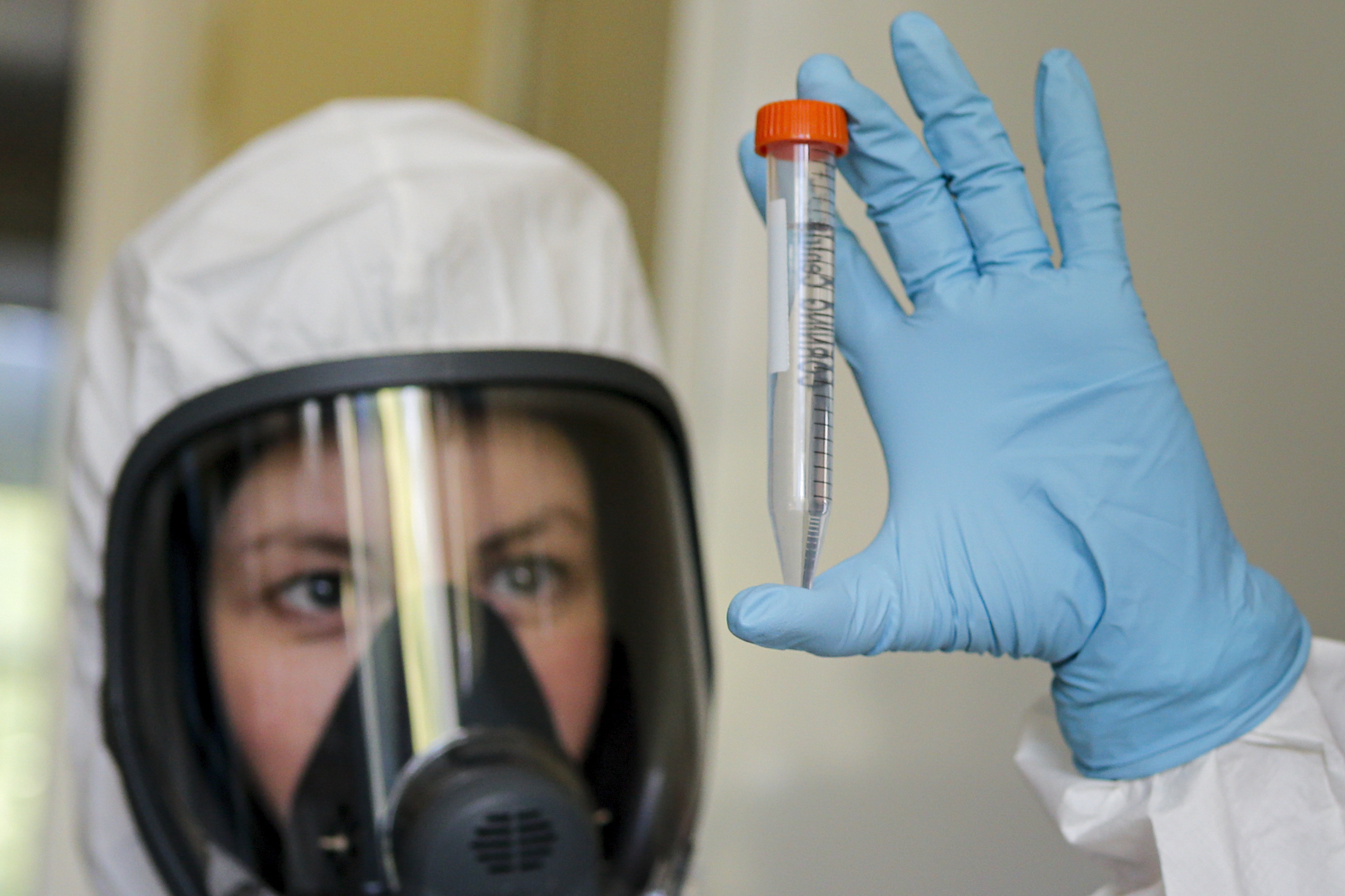 In this handout photo taken on Thursday, Aug. 6, 2020, and provided by Russian Direct Investment Fund, an employee shows a new vaccine at the Nikolai Gamaleya National Center of Epidemiology and Microbiology in Moscow, Russia. Russia on Tuesday, Aug. 11 became the first country to approve a coronavirus vaccine for use in tens of thousands of its citizens despite international skepticism about injections that have not completed clinical trials and were studied in only dozens of people for less than two months. (Alexander Zemlianichenko Jr/ Russian Direct Investment Fund via AP)