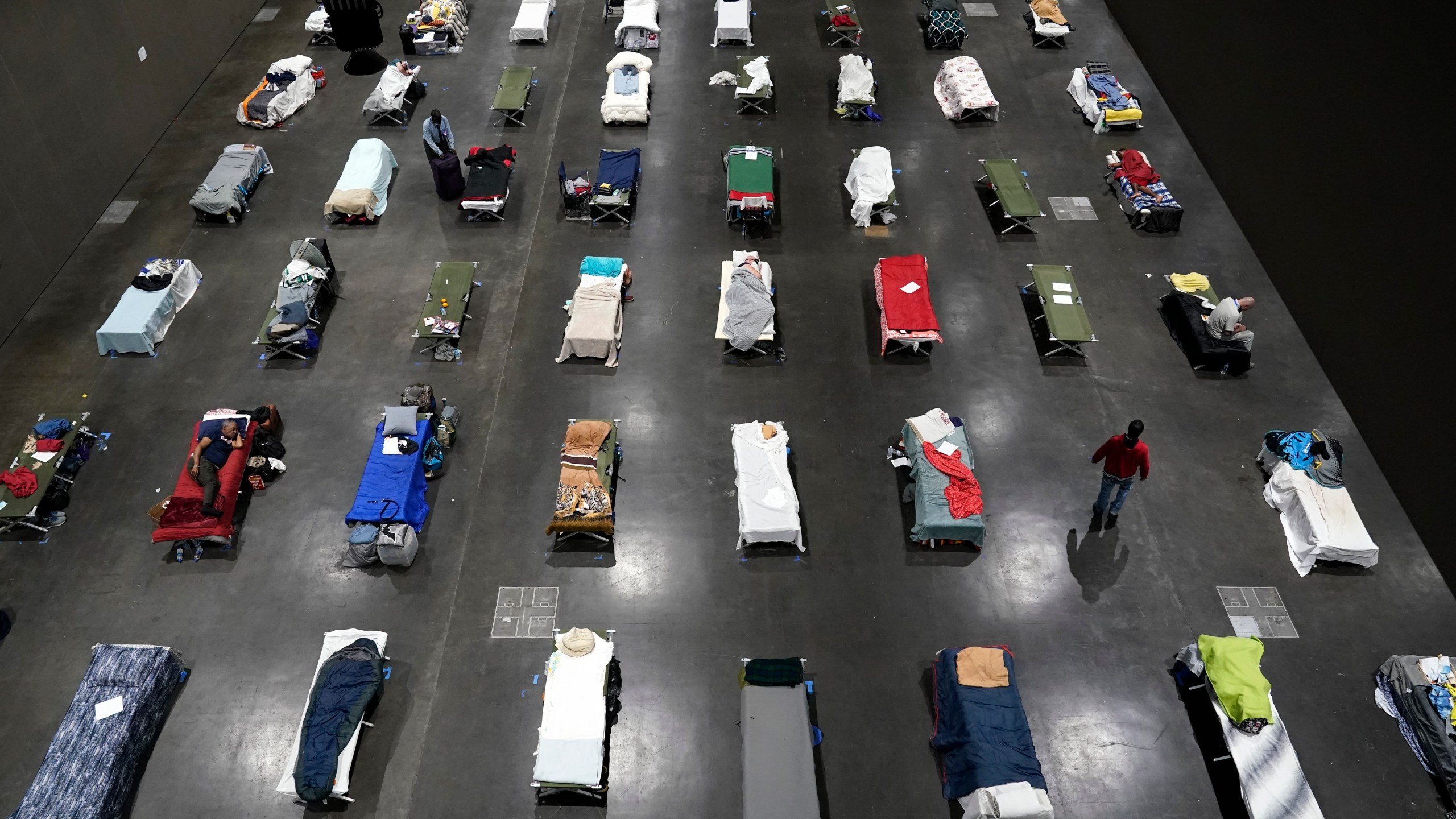 Beds fill a homeless shelter inside the San Diego Convention Center on Aug. 11, 2020, in San Diego. (AP Photo/Gregory Bull)