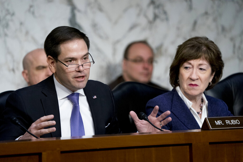 In this March 21, 2018 file photo, Sen. Marco Rubio, R-Fla., left, accompanied by Sen. Susan Collins, R-Maine, right, speaks before a Senate Intelligence Committee hearing on election security on Capitol Hill in Washington. The Senate intelligence committee has concluded that the Kremlin launched an aggressive effort to interfere in the 2016 presidential contest on behalf of Donald Trump. The Republican-led panel on Tuesday released its fifth and final report in its investigation into election interference. (AP Photo/Andrew Harnik)