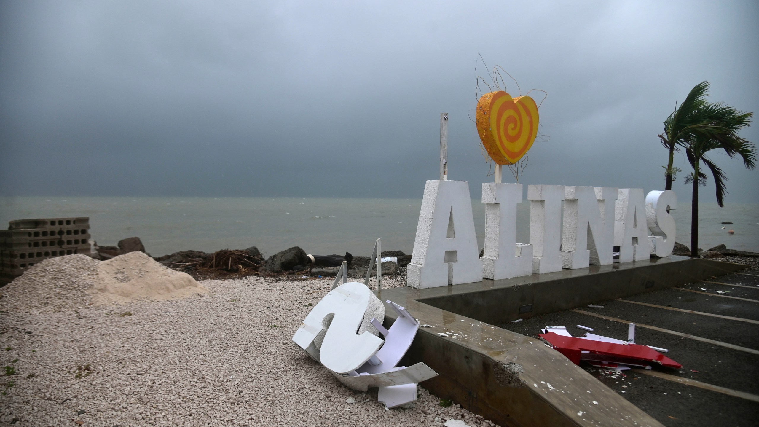 Remnants of a city sign lay on the beach damaged by Tropical Storm Laura in Salinas, Puerto Rico, on Aug. 22, 2020. (AP Photo/Carlos Giusti)