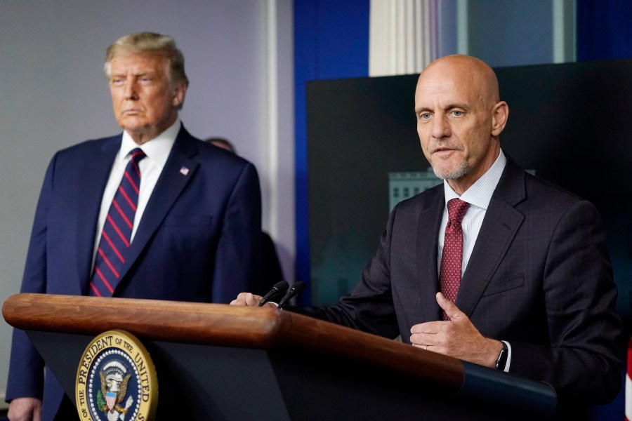 Donald Trump listens as Dr. Stephen Hahn, commissioner of the U.S. Food and Drug Administration, speaks during a media briefing in the James Brady Briefing Room of the White House, Sunday, Aug. 23, 2020, in Washington. (AP Photo/Alex Brandon)