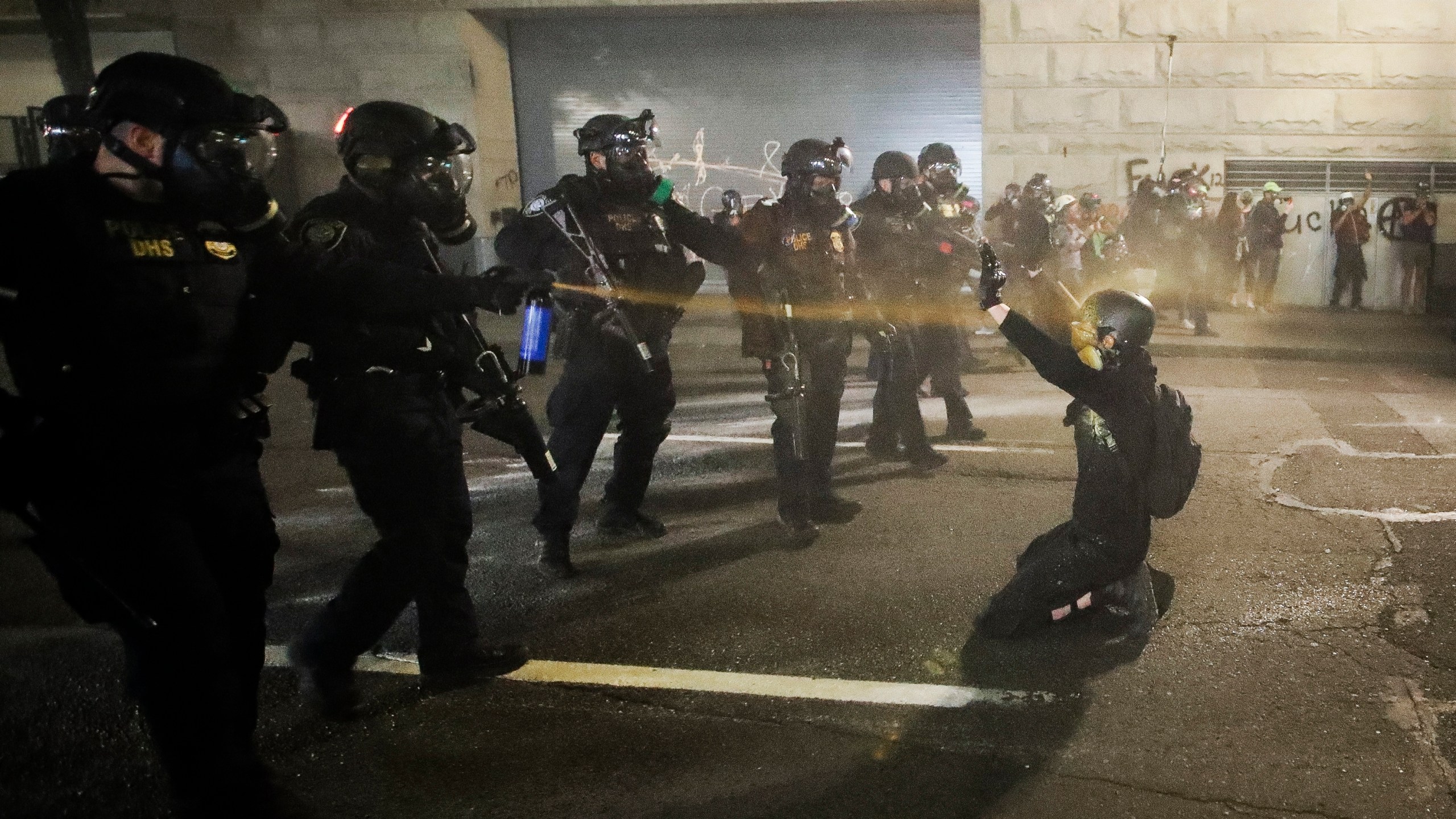 A demonstrator is pepper sprayed shortly before being arrested during a Black Lives Matter protest at the Mark O. Hatfield United States Courthouse in Portland, Oregon, on July 30, 2020. (Marcio Jose Sanchez / Associated Press)