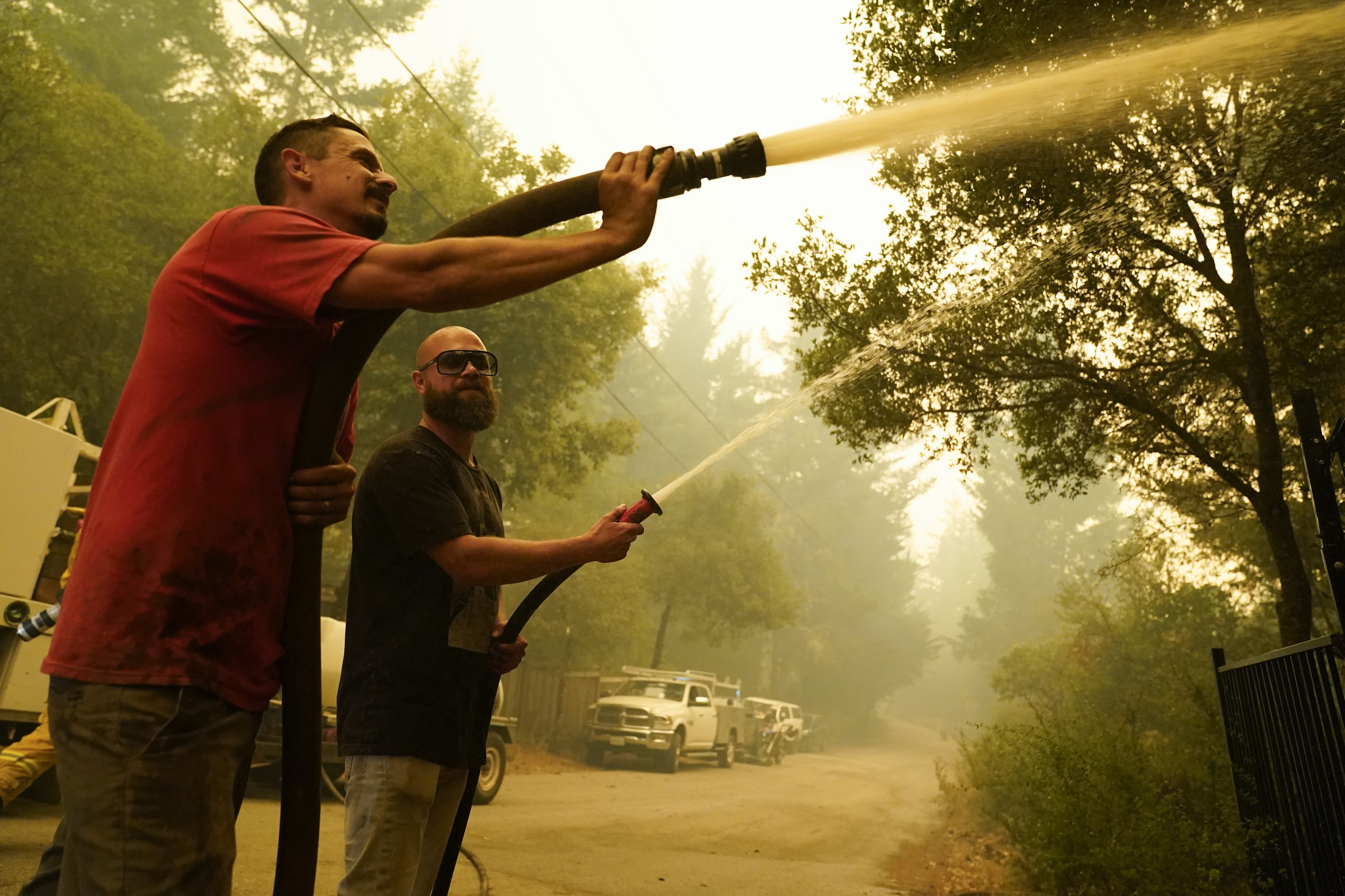 Civilian volunteers fight the CZU Lightning Complex Fire in Bonny Doon, California, on Aug. 20, 2020. (AP Photo/Marcio Jose Sanchez, File)