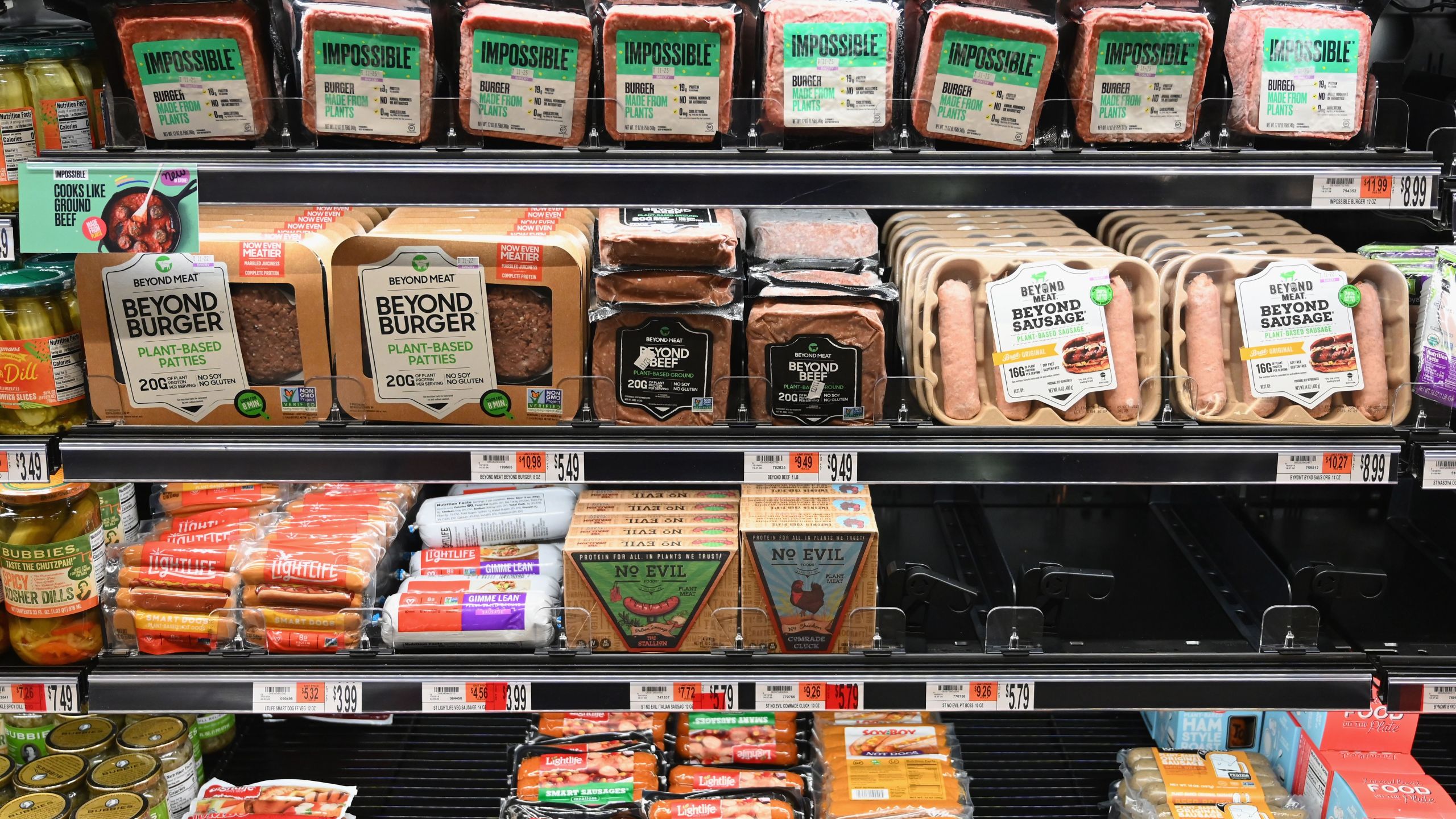 Packages of "Impossible Burger" and Beyond Meat sit on a shelf for sale on November 15, 2019, in New York City. (ANGELA WEISS/AFP via Getty Images)