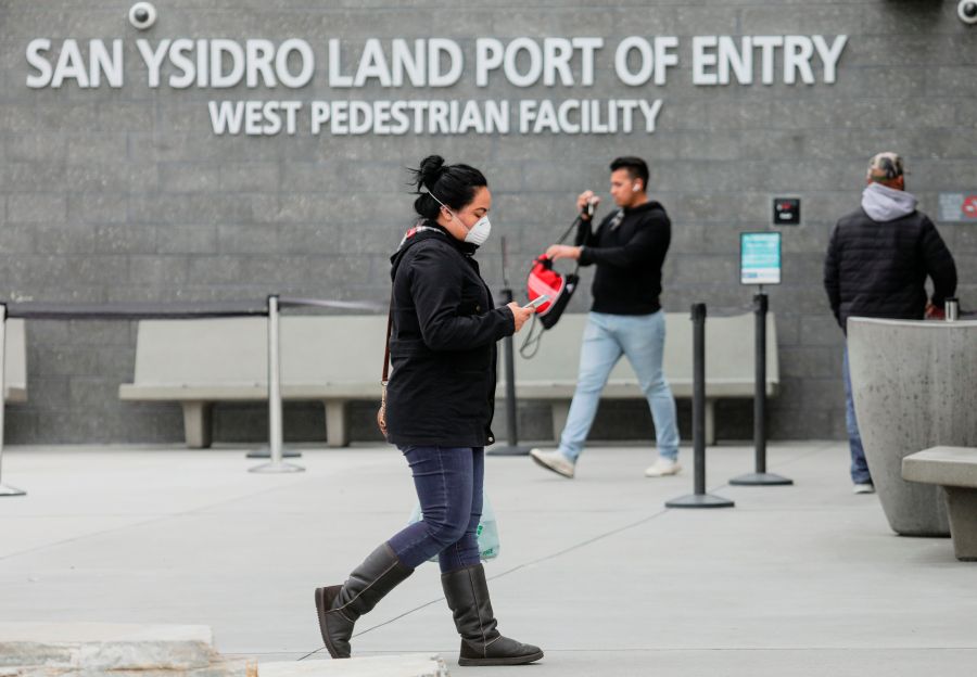 Pedestrians walk out of the United States Port of Entry after coming from Mexico in San Ysidro on March 20, 2020. (SANDY HUFFAKER/AFP via Getty Images)