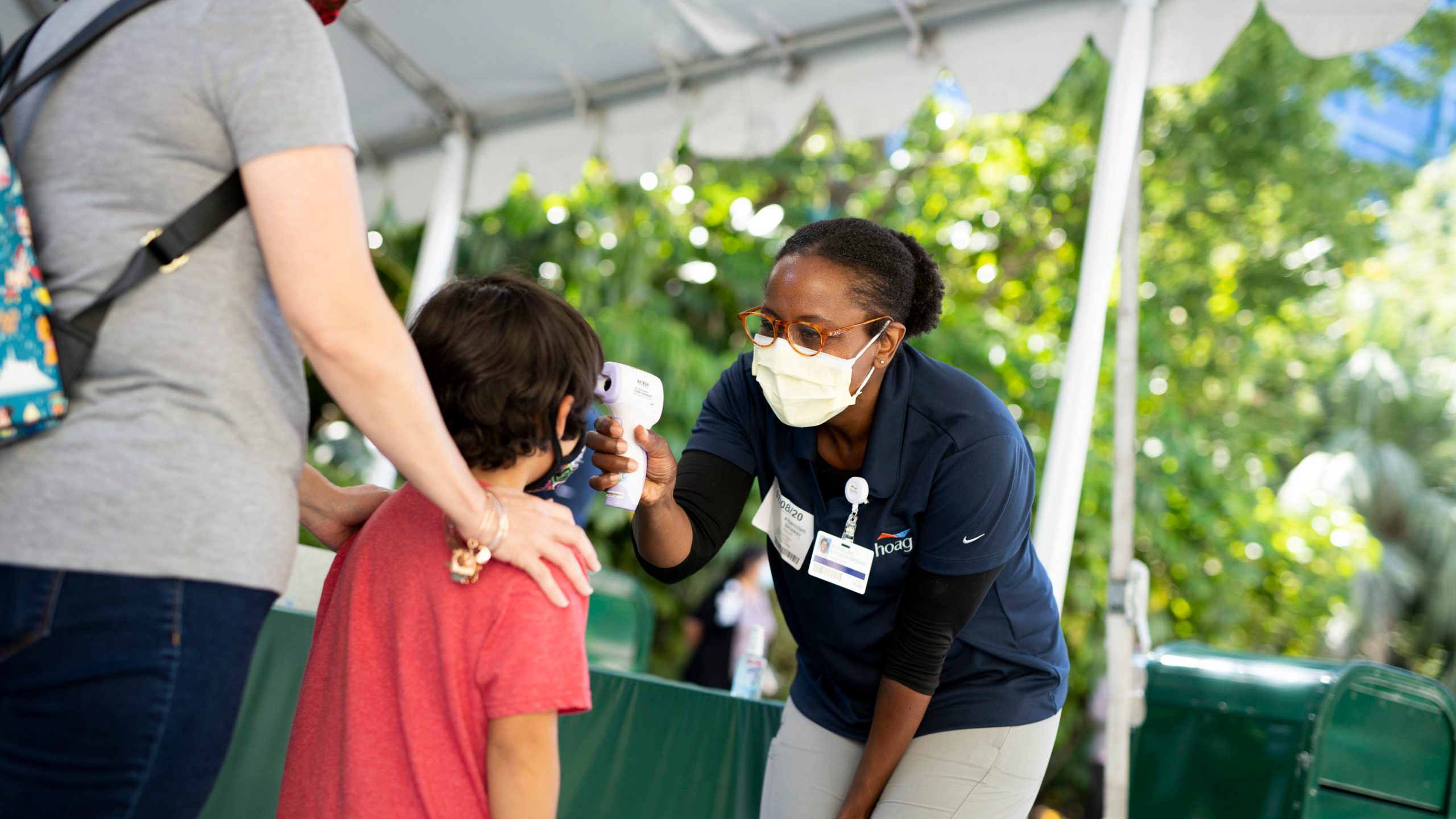 A child has his temperature taken in Downtown Disney on July 9, 2020, in Anaheim, Orange County. (Derek Lee/Disneyland Resort via Getty Images)