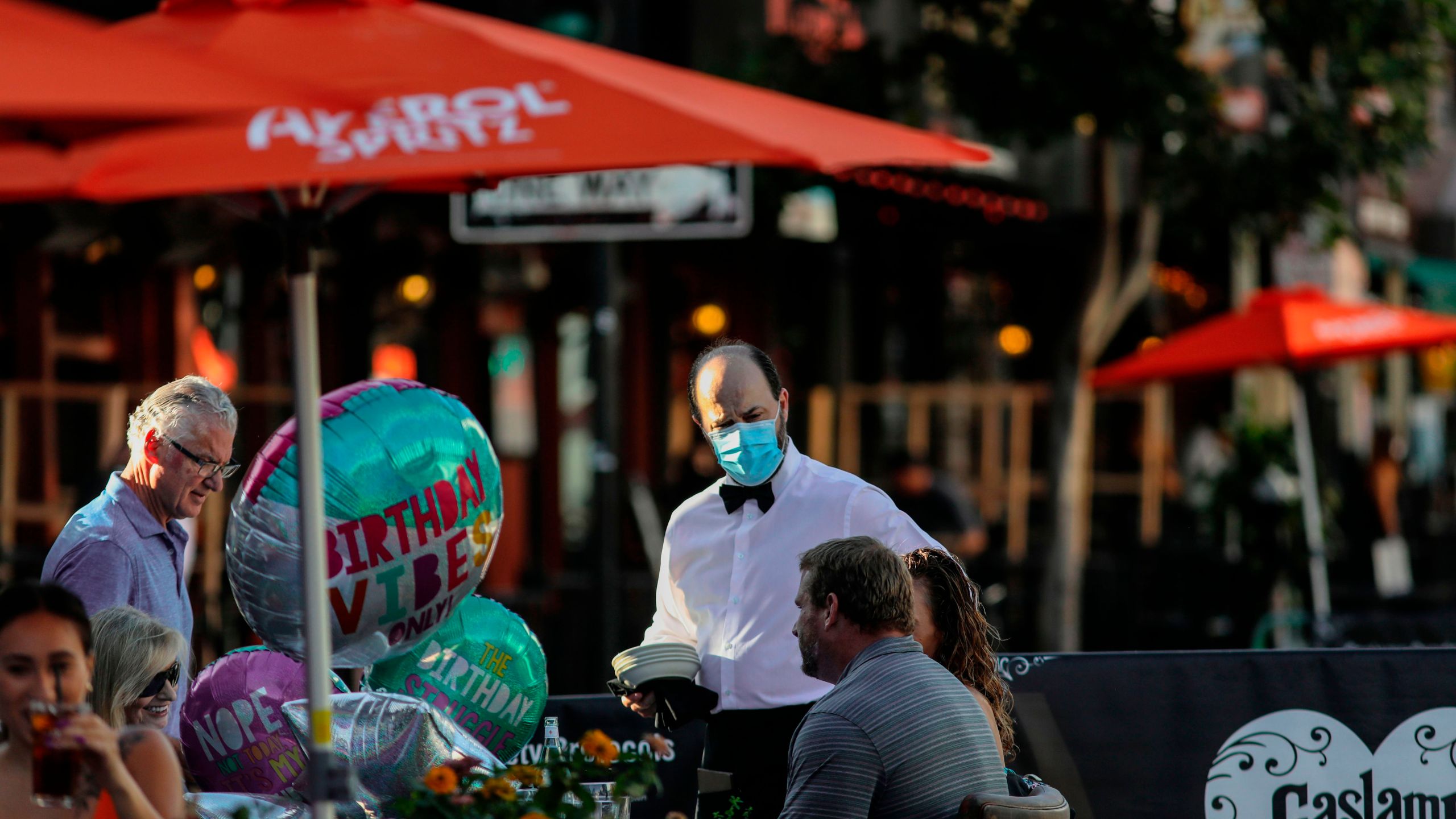 Patrons dine at an outdoor restaurant along 5th Avenue in The Gaslamp Quarter in downtown San Diego on, July 17, 2020. (SANDY HUFFAKER/AFP via Getty Images)