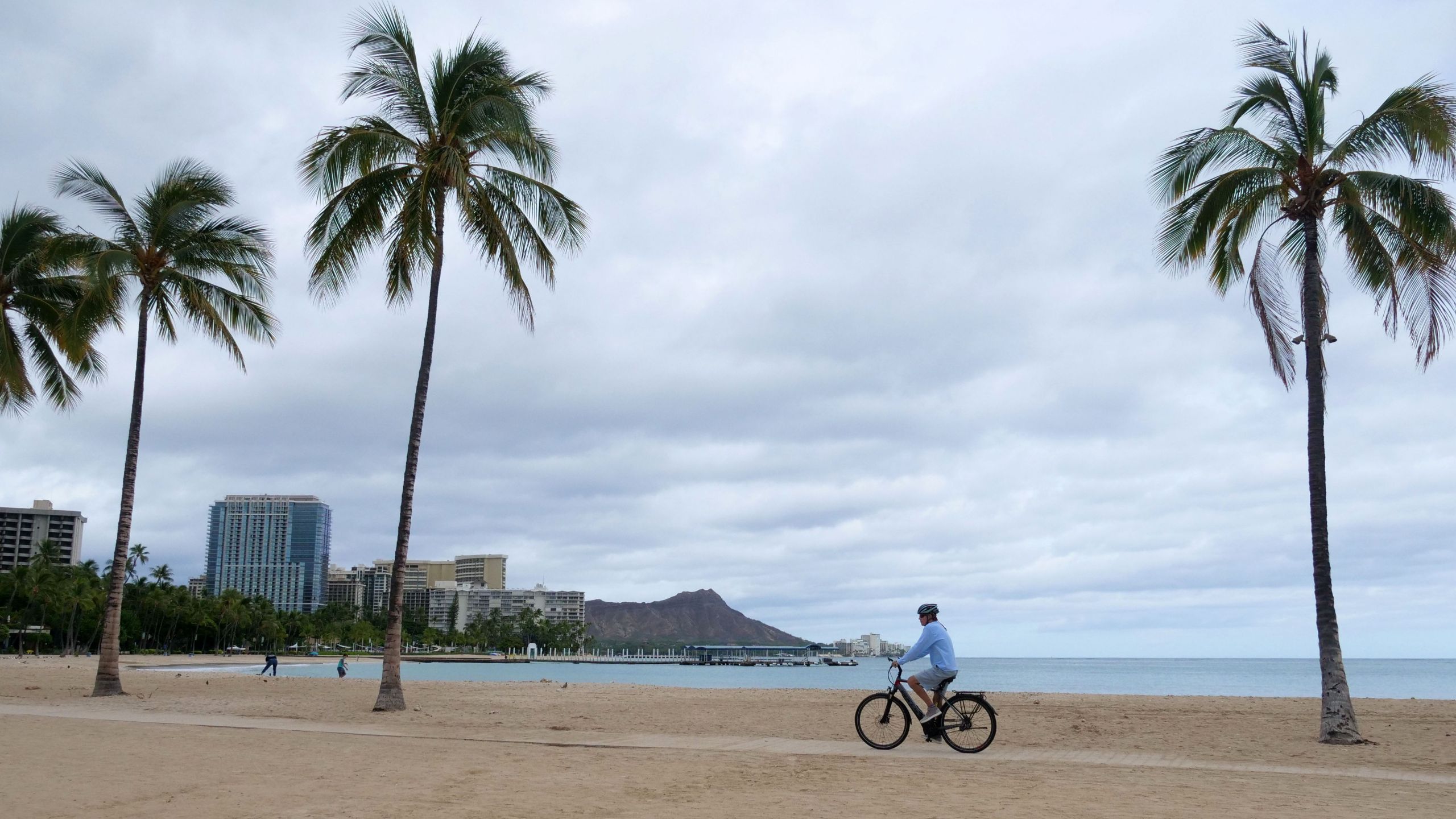 A cyclist rides along an empty Waikiki Beach on July 26, 2020. (RONEN ZILBERMAN/AFP via Getty Images)