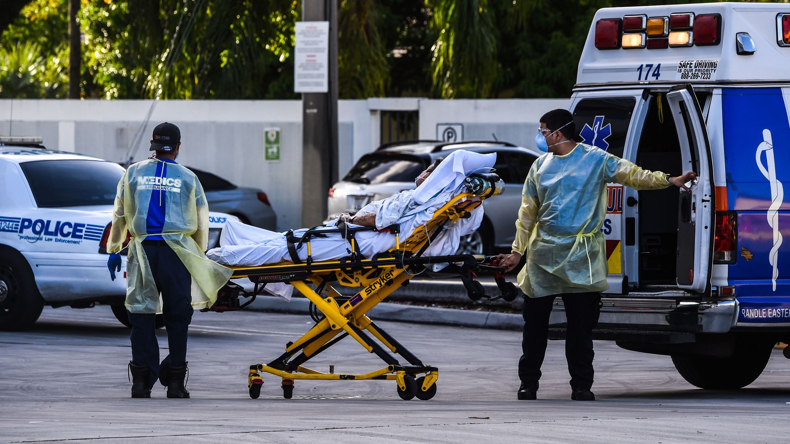 Medics transfer a patient on a stretcher from an ambulance outside of Emergency at Coral Gables Hospital where Coronavirus patients are treated in Coral Gables near Miami, on July 30, 2020. Florida has emerged as a major new epicenter of the U.S. battle against the disease, with confirmed cases recently surpassing New York and now second only to California. (CHANDAN KHANNA/AFP via Getty Images)