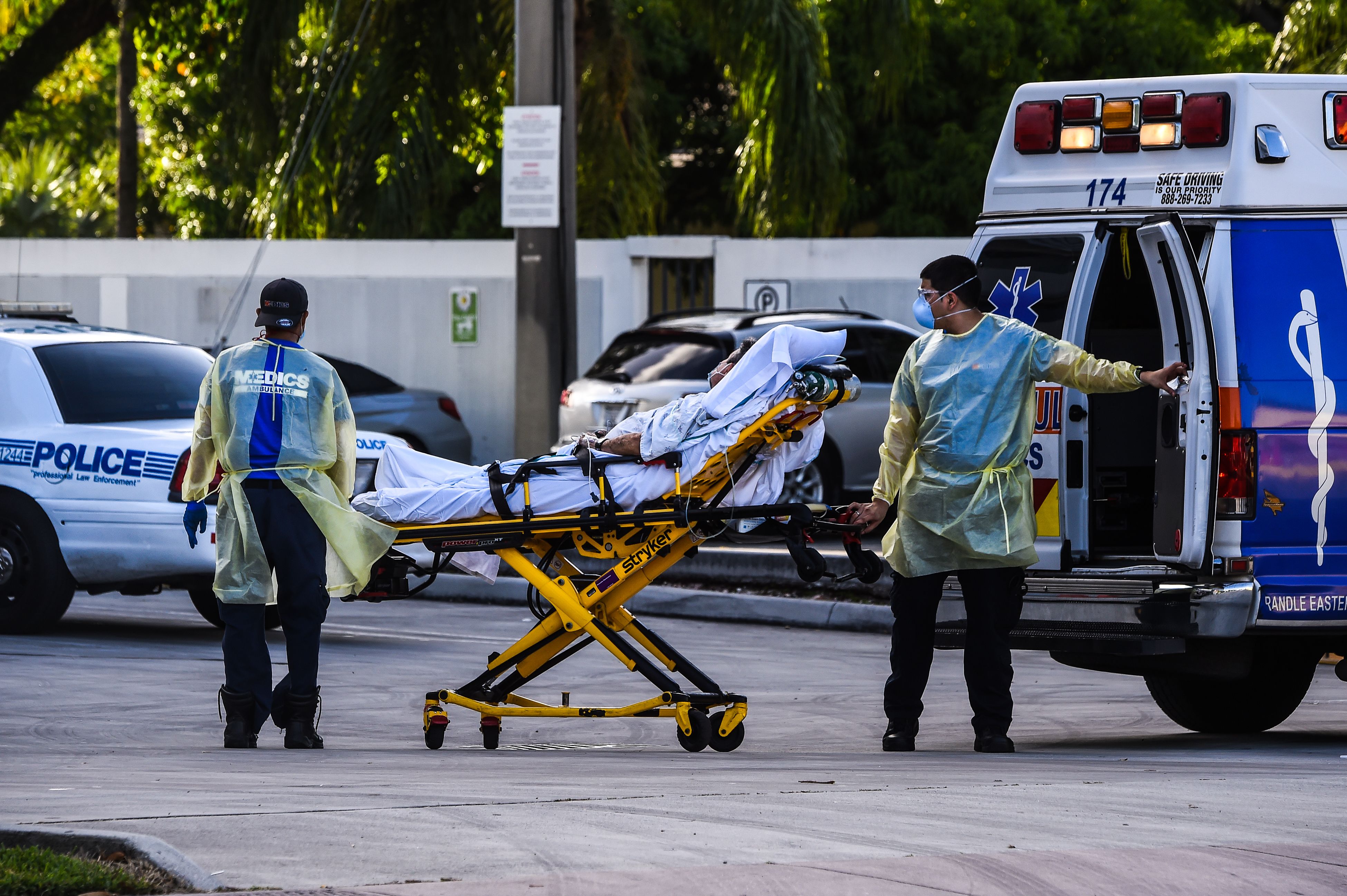 Medics transfer a patient on a stretcher from an ambulance outside of Emergency at Coral Gables Hospital where Coronavirus patients are treated in Coral Gables near Miami, on July 30, 2020. Florida has emerged as a major new epicenter of the U.S. battle against the disease, with confirmed cases recently surpassing New York and now second only to California. (CHANDAN KHANNA/AFP via Getty Images)