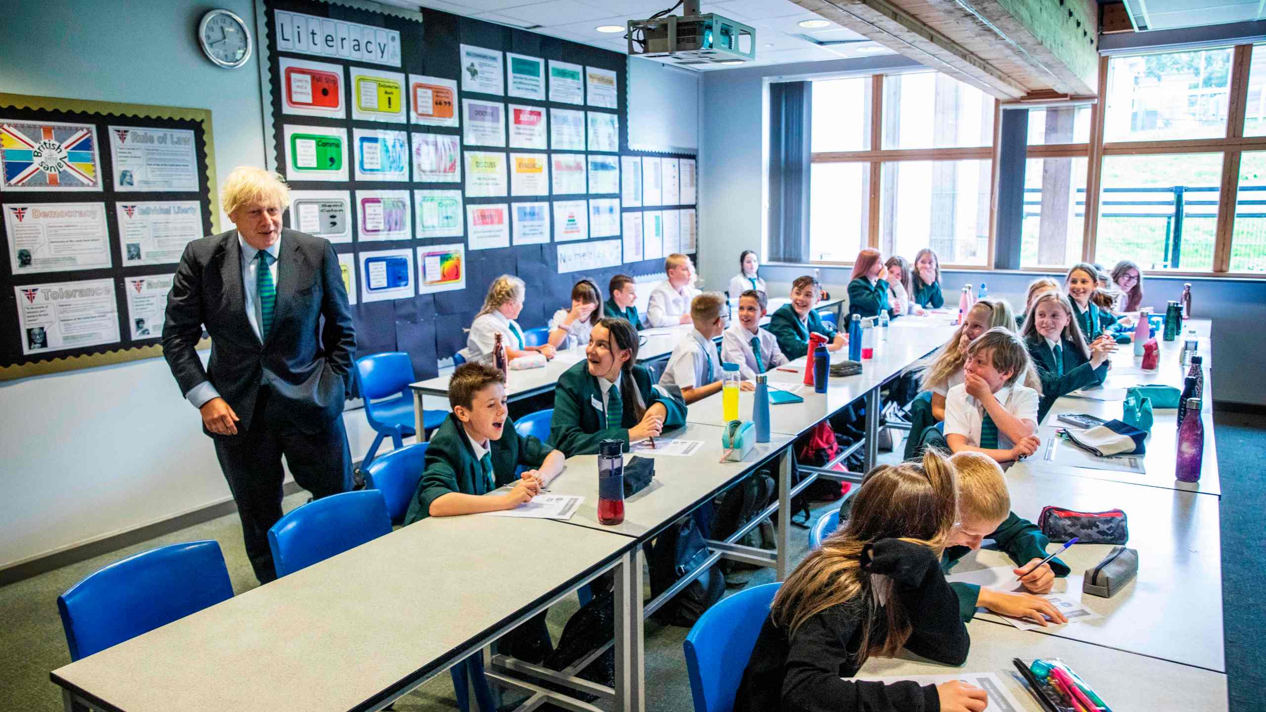 Britain's Prime Minister Boris Johnson talks to a class of year-seven pupils on their first day at Castle Rock school, Coalville, central England on Aug. 26, 2020. (Jack Hill / POOL / AFP via Getty Images)