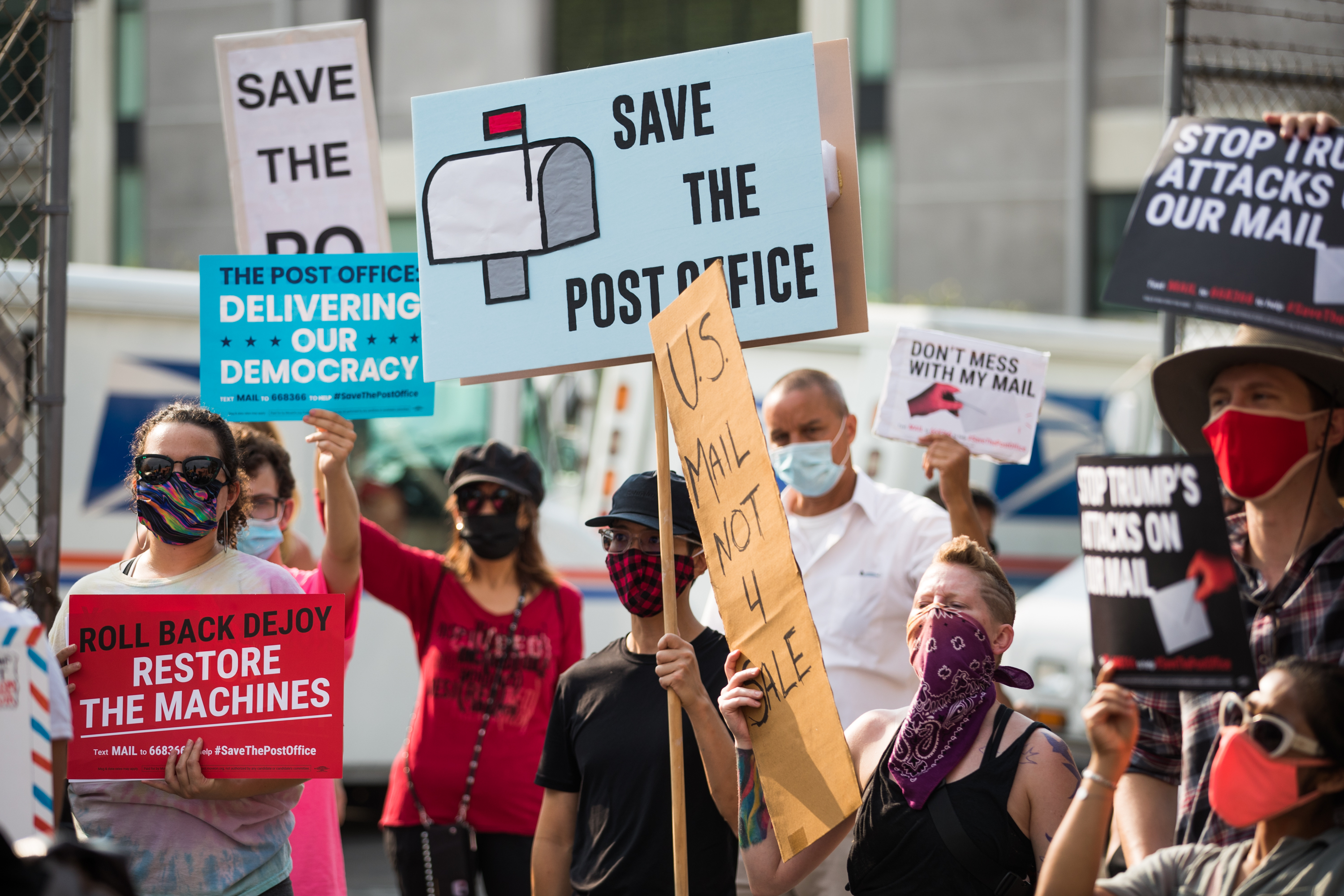 Rally goers gather at a post office to protest the Trump administration's handling of the US Postal System at the Rally to Save the Post Office on Aug. 22, 2020 in Los Angeles. (Rich Fury/Getty Images for MoveOn)