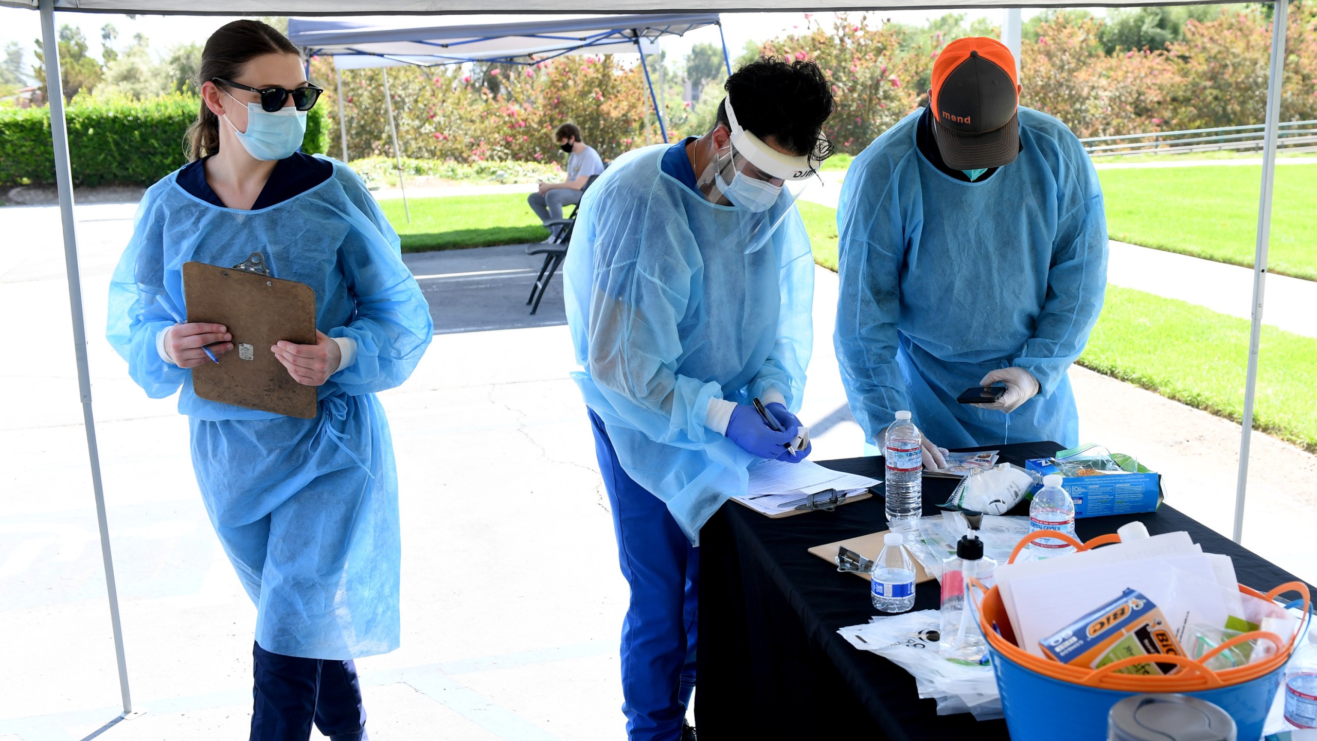 Mend Urgent Care workers wearing personal protective equipment perform drive-up COVID-19 testing for students and faculty on the first day of school at Woodbury University in Burbank on Aug. 24, 2020. (Kevin Winter/Getty Images)