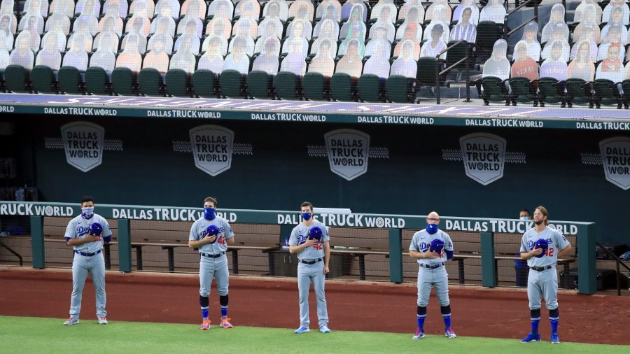 Members of the Los Angeles Dodgers stand during the National Anthem before a MLB baseball game against the Texas Rangers on Aug. 28, 2020, in Arlington, Texas. All players are wearing #42 in honor of Jackie Robinson Day. (Tom Pennington/Getty Images)