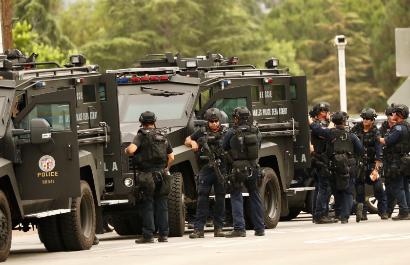 LAPD SWAT officers muster during a search for a murder suspect in Van Nuys in 2019. (Al Seib / Los Angeles Times)