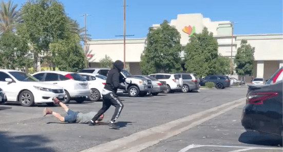 A screenshot from a video taken by a bystander shows a man being robbed in Huntington Park on July 30, 2020.