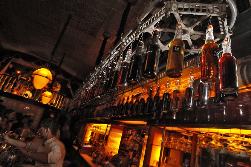 Bottles hang from a rotating delivery mechanism over the bar at Club Sassafras in this undated photo. (Robert Gauthier / Los Angeles Times)