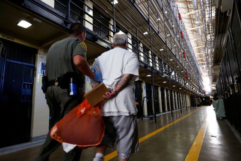 A death row inmate is escorted back to his cell after spending time in the yard at San Quentin State Prison.(Gary Coronado / Los Angeles Times)