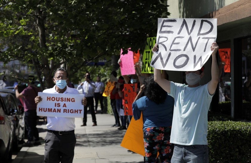 A housing rights and anti-eviction protest in Valley Village in May. The Legislature on Monday sent the governor a bill that extends protections against evictions until Jan. 31, 2021 as long as tenants pay at least 25% of their rent. (Myung J. Chun / Los Angeles Times)