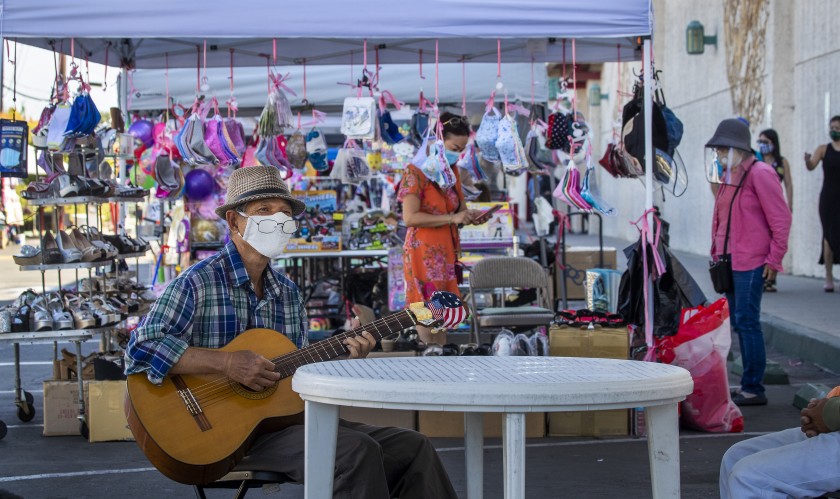 Keith Tran of Santa Ana plays guitar at the Asian Garden Mall in Westminster in this undated photo. (Allen J. Schaben / Los Angeles Times)