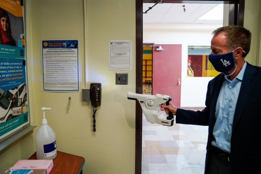 Los Angeles Unified School District Supt. Austin Beutner demonstrates the use of sanitizing tools while taking a tour of Burbank Middle School in this undated photo. (Kent Nishimura / Los Angeles Times)