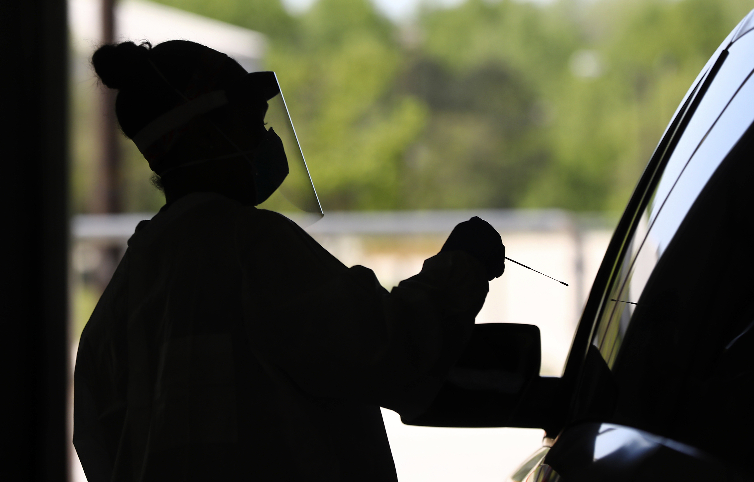 A nurse at Emory Hospital takes a nasal swab at a drive-through coronavirus testing site in Conyers, Georgia. (Curtis Compton/Atlanta Journal-Constitution/AP via CNN Wire)