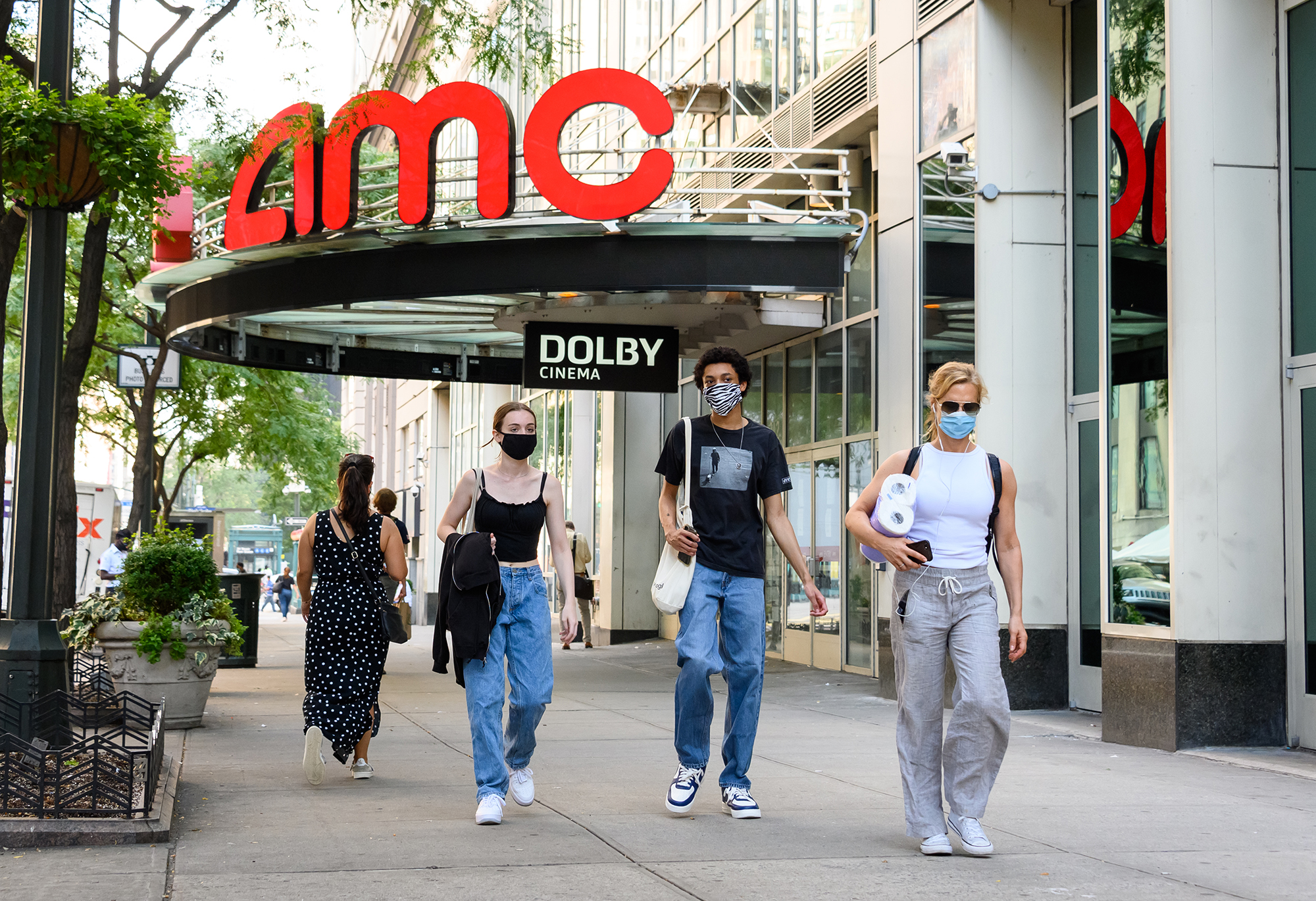 People wear protective face masks outside the AMC 34th Street 14 movie theater as the city continues Phase 4 of re-opening following restrictions imposed to slow the spread of coronavirus on July 31, 2020 in New York City. (Noam Galai/Getty Images)