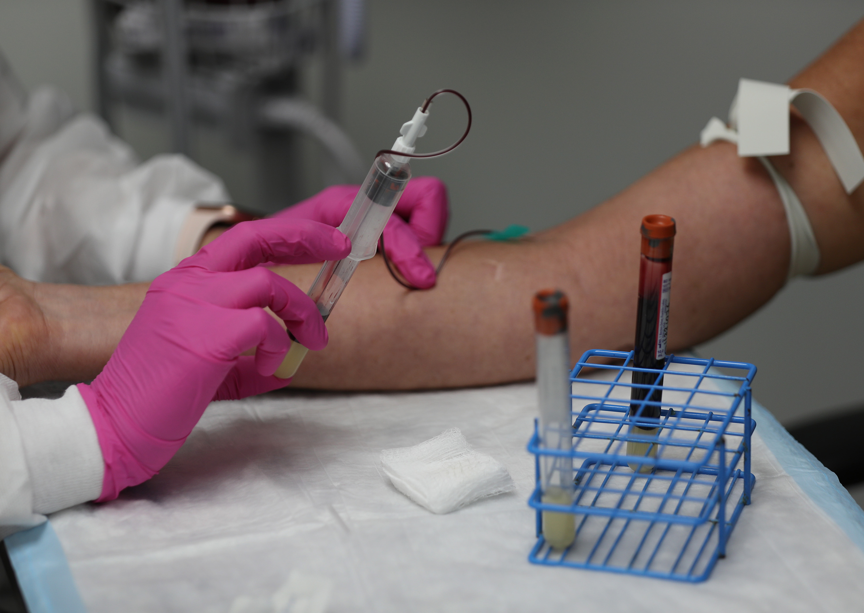 Leyda Valentine, an assistant coordinator, takes blood from Lisa Taylor as she participates in a COVID-19 vaccination study at Research Centers of America on August 07, 2020 in Hollywood, Florida. (Joe Raedle/Getty Images)