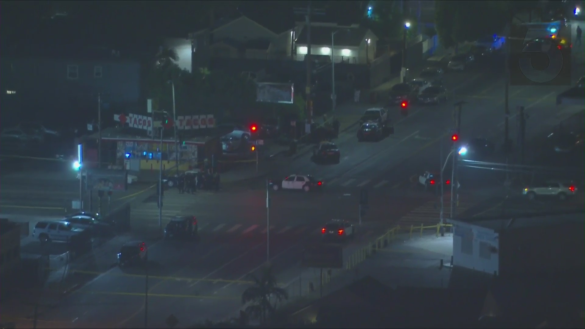 Police vehicles are parked at the scene of a reported shooting in the Green Meadows neighborhood of South Los Angeles on Aug. 15, 2020. (KTLA)