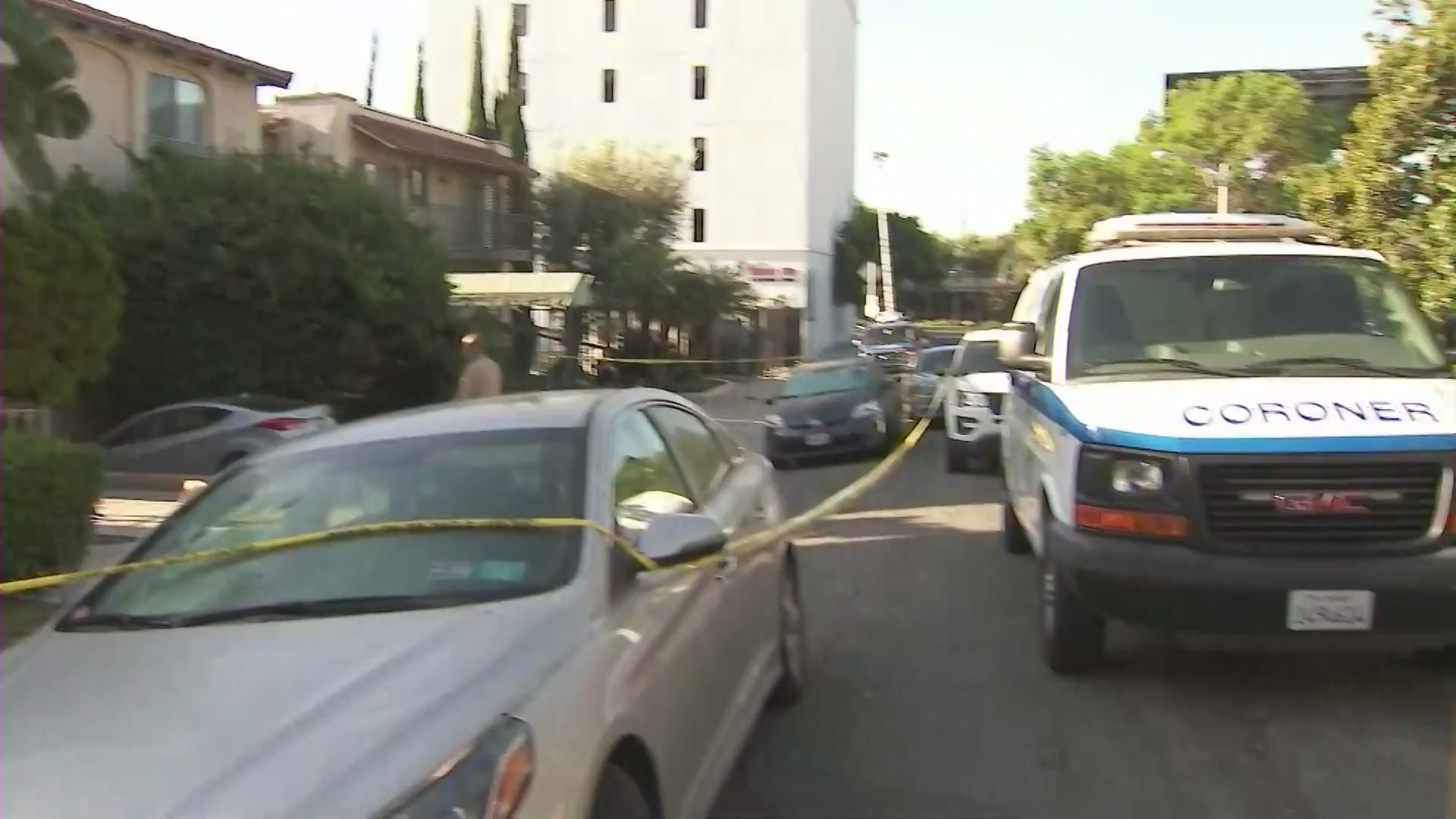 A coroner's van is seen in the 1100 block of North Olive Drive in West Hollywood, where officials are investigating a man's death on Aug. 8, 2020. (KTLA)