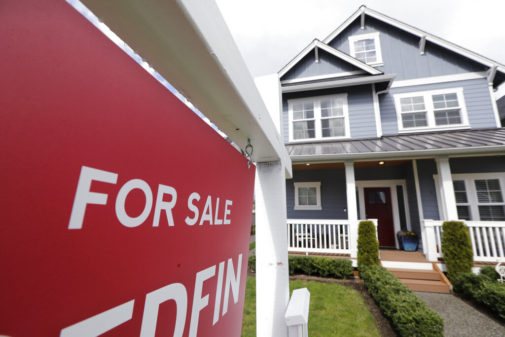 In this April 1, 2020 photo, a "For Sale" sign stands in front of a home that is in the process of being sold in Monroe, Wash., outside of Seattle. (AP Photo/Elaine Thompson, File)