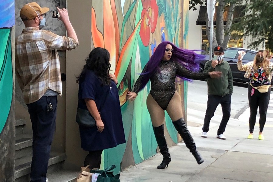 This Aug. 28, 2020 photo shows Amoura Teese, center, performing on a sidewalk for customers in San Francisco. (AP Photo/Haven Daley)