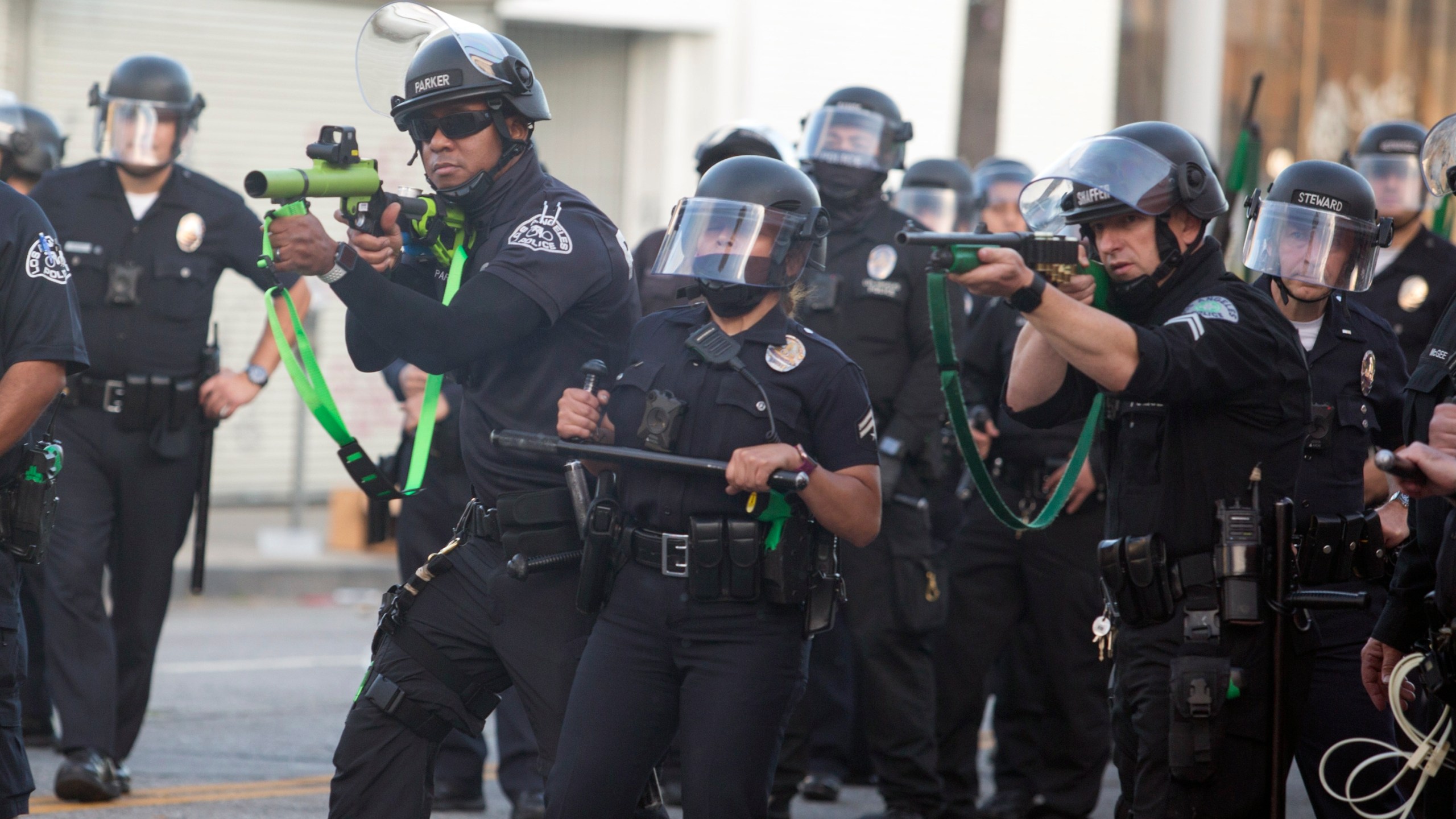 Police aim weapons on demonstrators protesting the death of George Floyd in Los Angeles, Saturday, May 30, 2020. (AP Photo/Ringo H.W. Chiu, File)