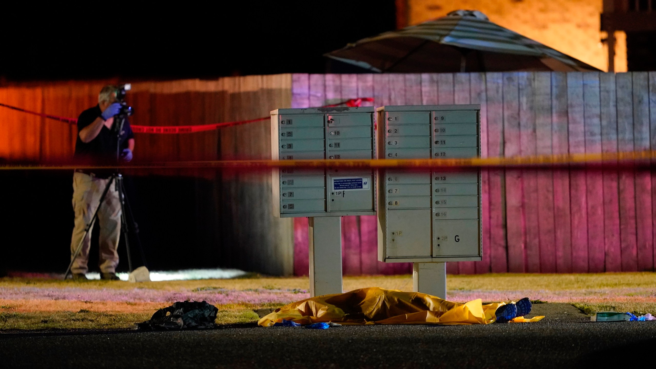 Officials work at a scene late on Sept. 3, 2020, where a man suspected of fatally shooting a supporter of a right-wing group in Portland, Oregon, the week before was killed as investigators moved in to arrest him in Lacey, Washington. (Ted Warren / Associated Press)