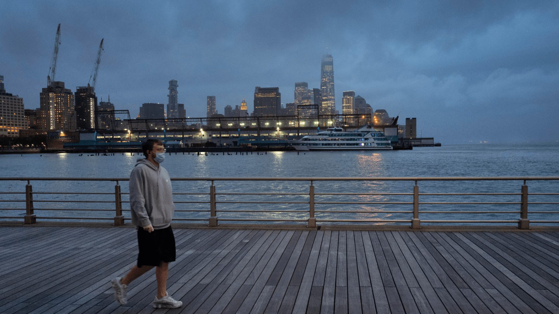 In this April 30, 2020, file photo, a man wears a face mask as he walks on Pier 45 in Hudson River Park in New York. (AP Photo/Mark Lennihan, File)