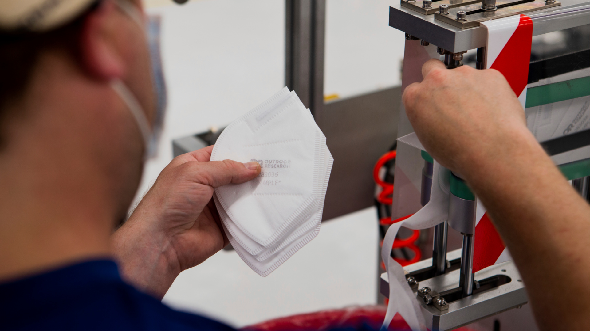 A worker handles filter material for face masks in Seattle. A key challenge for N95 mask manufacturers racing to meet spiking demand is scarcity of meltblown textile. (Gerardo Villalobos/Outdoor Research via AP)