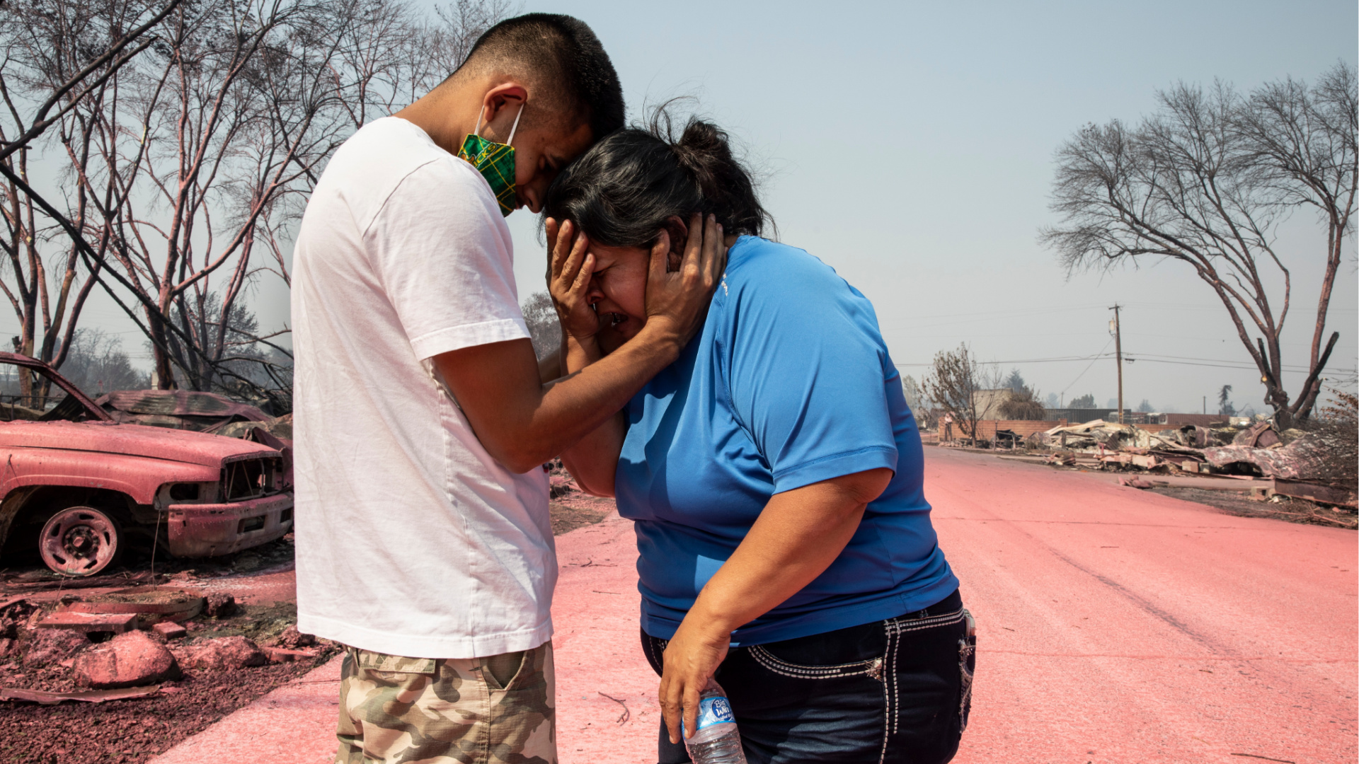 A mother is consoled consoled by her son after seeing their destroyed mobile home at the Talent Mobile Estates on Sept. 10, 2020, in Talent, Oregon, after wildfires devastates the region. (AP Photo/Paula Bronstein)