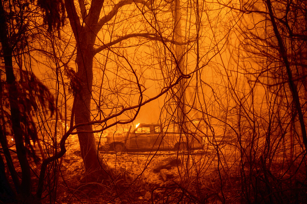 A scorched car rests in a clearing following the Bear Fire in Butte County on Sept. 9, 2020. (AP Photo/Noah Berger)