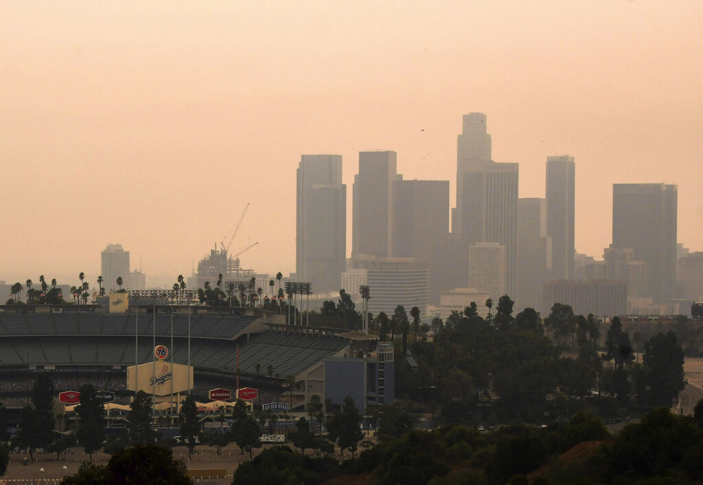 Downtown Los Angeles and Dodger Stadium are shrouded, looking south from Elysian Fields through the smoke from the Bobcat and the El Dorado fires, Friday, Sept. 11, 2020. (Keith Birmingham/The Orange County Register via AP)