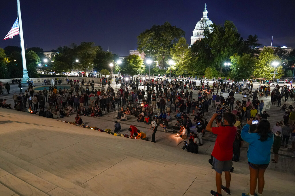 People gather at the Supreme Court on Sept. 18, 2020, after the court announced that Justice Ruth Bader Ginsburg died of metastatic pancreatic cancer at age 87. (Alex Brandon / Associated Press)